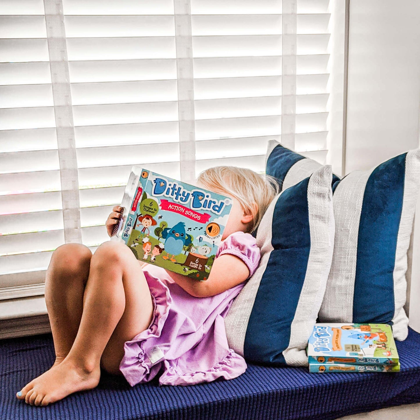 Child reading ditty bird book